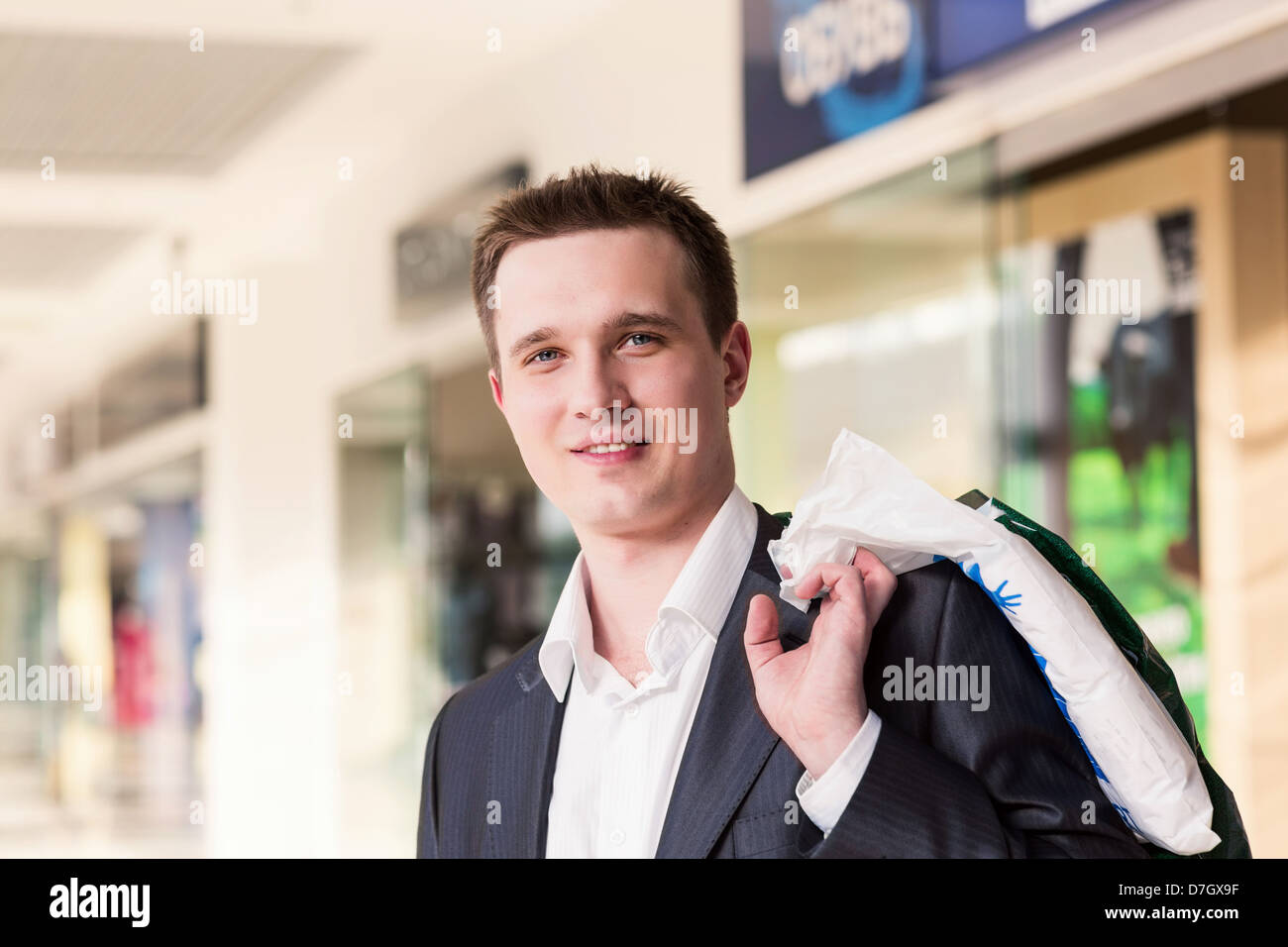 Attractive young man shopping with bags at the store Stock Photo - Alamy