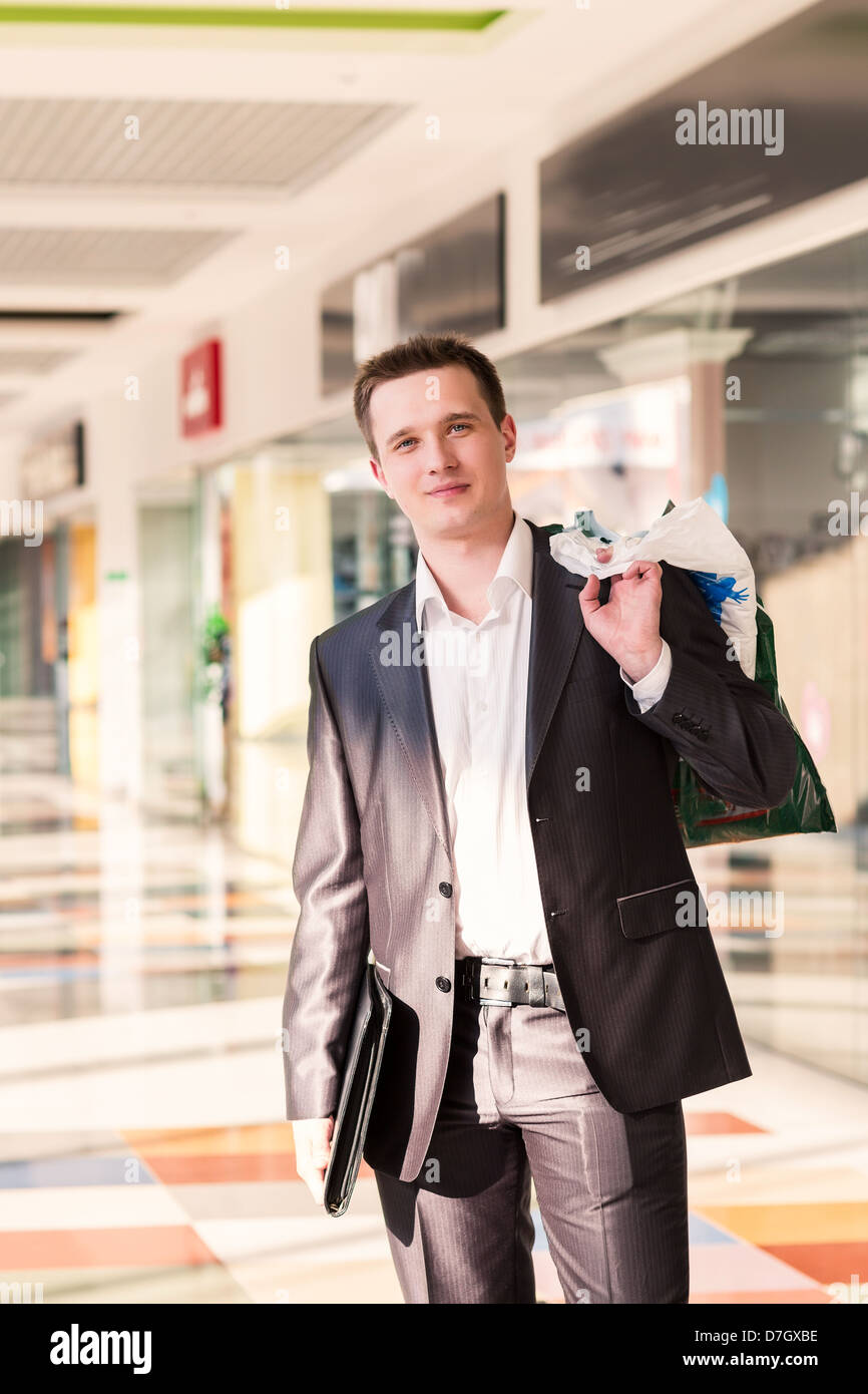 Attractive young man shopping with bags at the store Stock Photo - Alamy