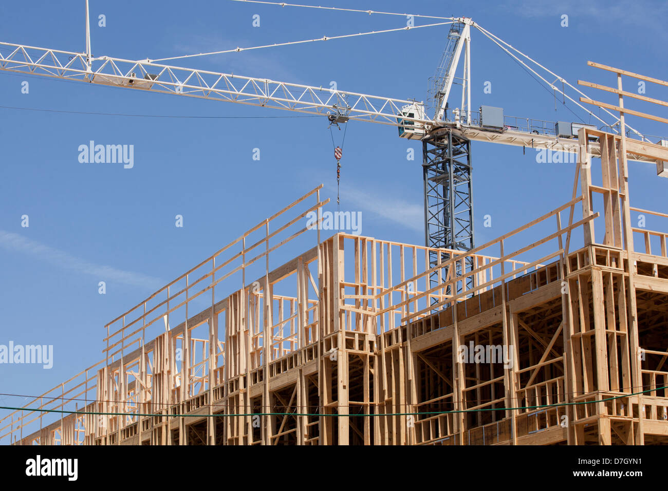 A tower crane over construction site Stock Photo