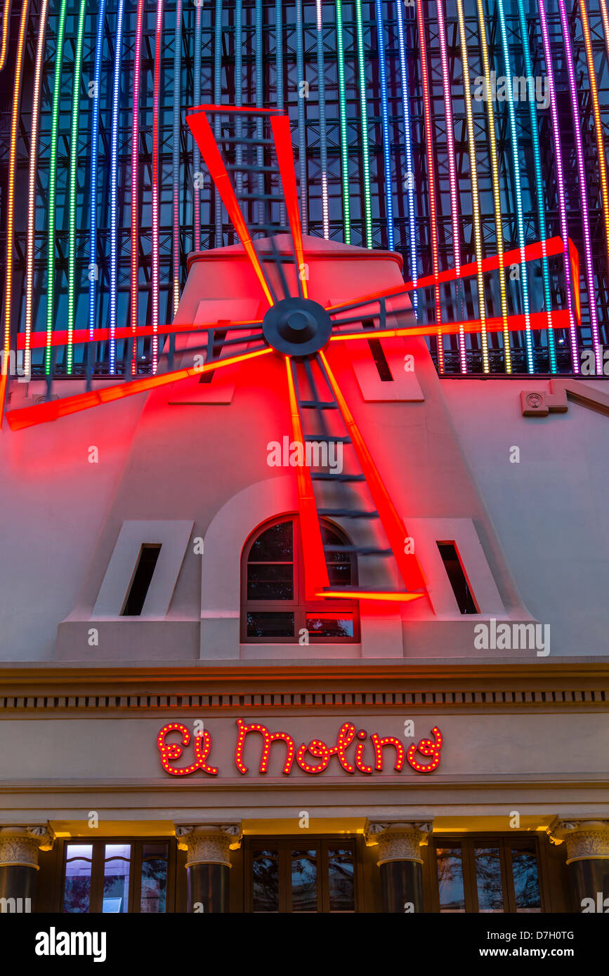 The glowing red windmill on the facade of famous El Molino cabaret theatre, Barcelona, Catalonia, Spain Stock Photo