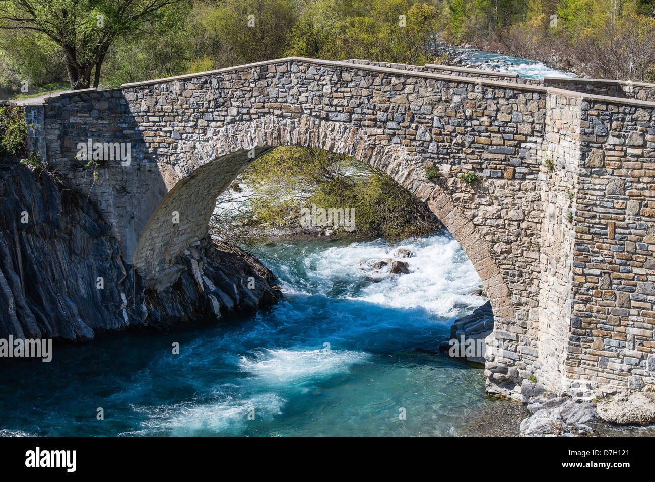The Puente de la Glera arch stone bridge over Ara River, Torla, Huesca, Aragon, Spain Stock Photo