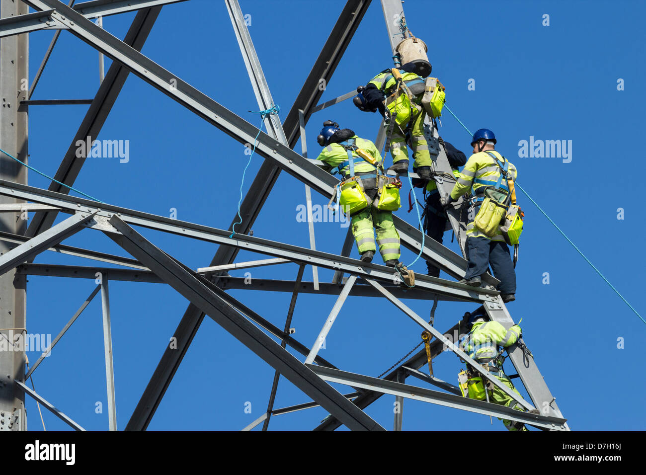 Workers constructing 145m pylon to carry power lines across the river Tees at Middlesbrough, Cleveland, England, UK Stock Photo