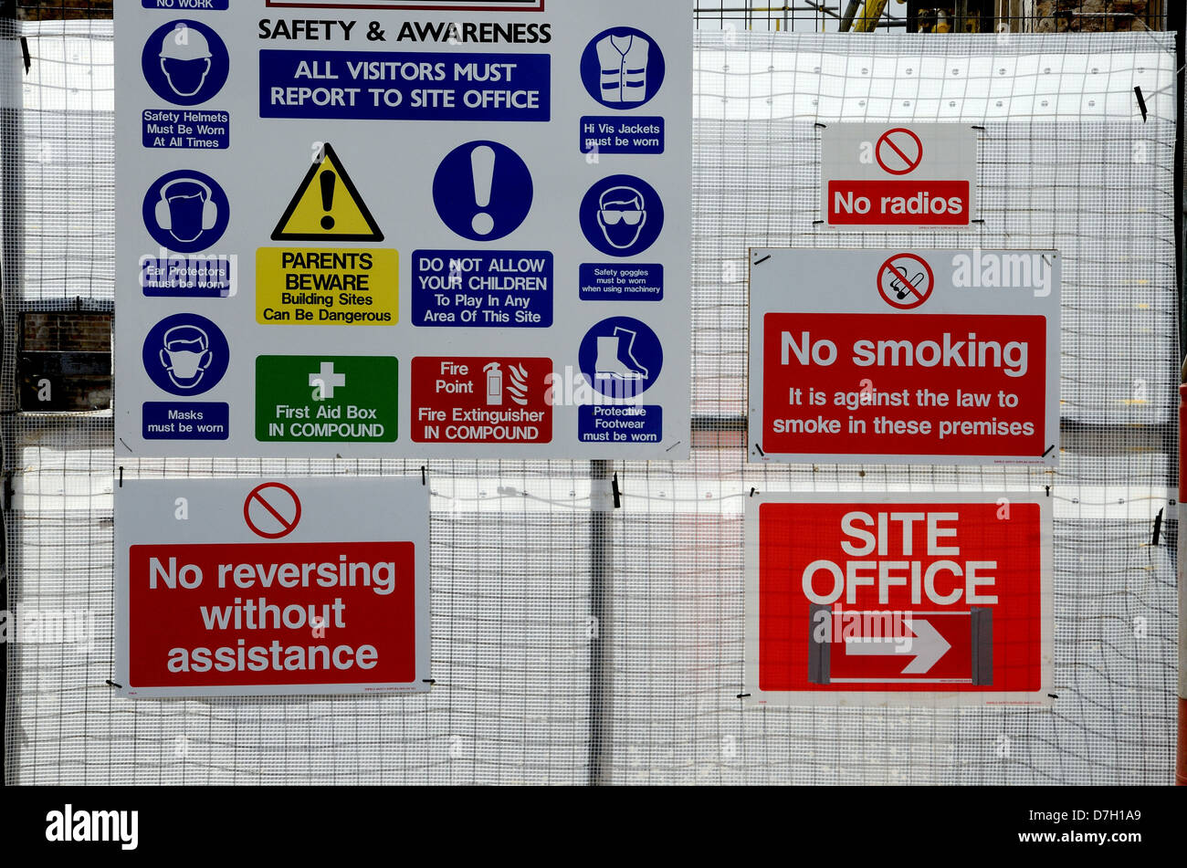 A multitude of Health and Safety warning signs on gate to a building site Stock Photo