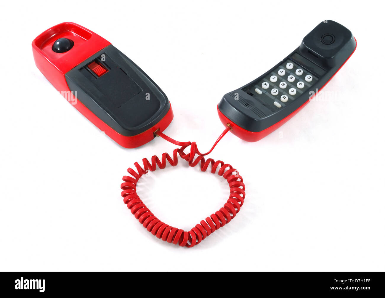 Little and old red and black phone with heart shaped cable Stock Photo