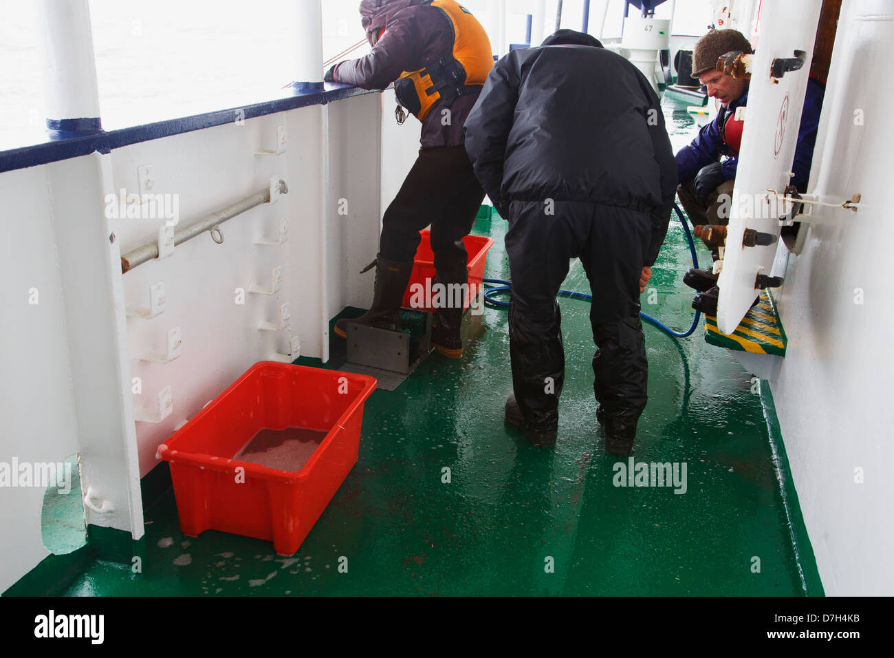 Boot cleaning on the icebreaker Ortelius, Hannah Point, Livingston Island Antarctica. Stock Photo
