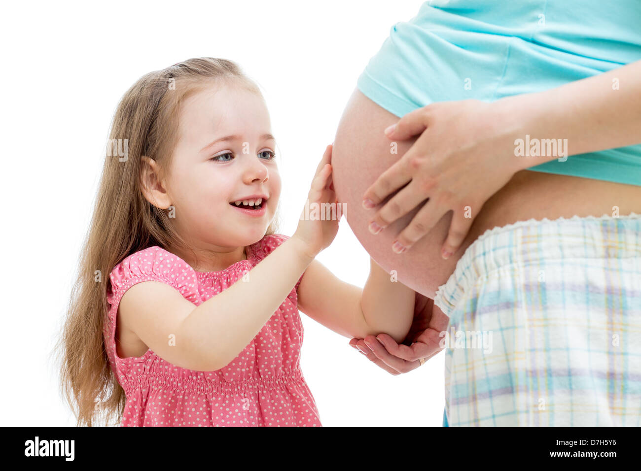 kid girl touches pregnant mother's belly isolated Stock Photo - Alamy