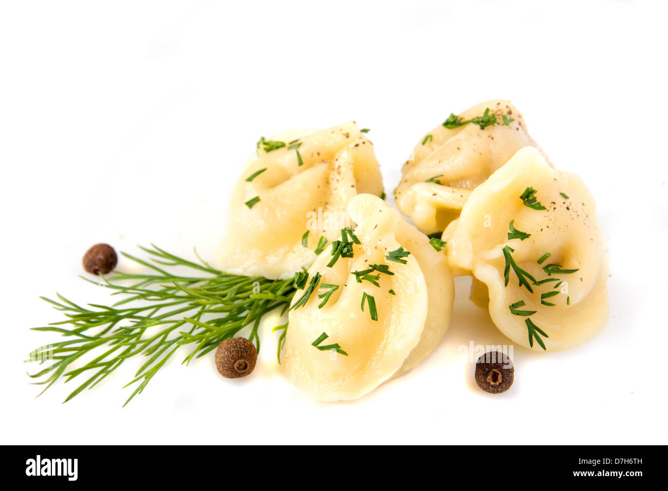 Meat dumplings (pelmeni) with dill (fennel) and pepper isolated on a white background, close up. Stock Photo