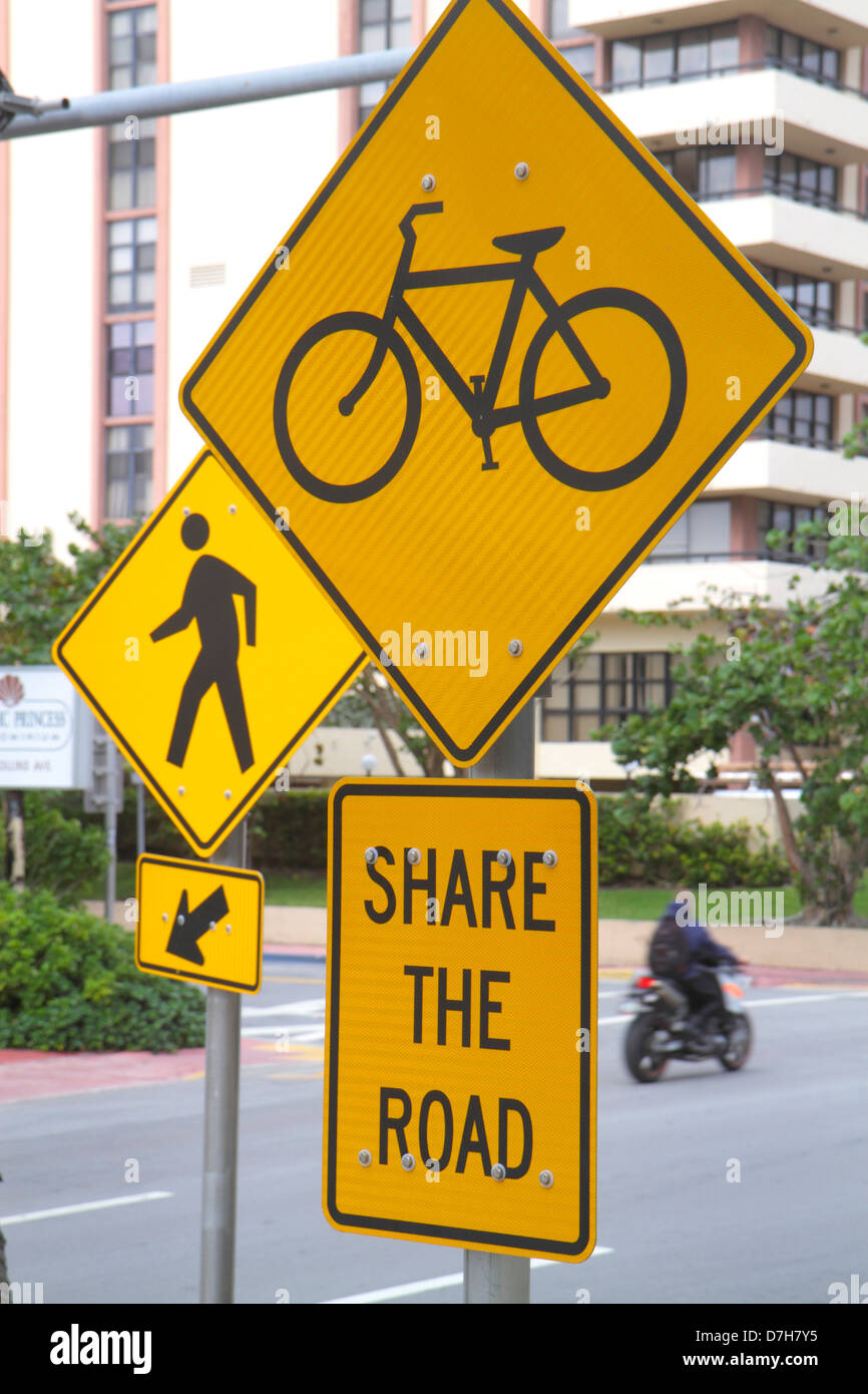Miami Beach Florida,Collins Avenue,traffic signs,bicycle,bicycling,riding,biking,rider,crosswalk,share the road,symbol,FL121130047 Stock Photo