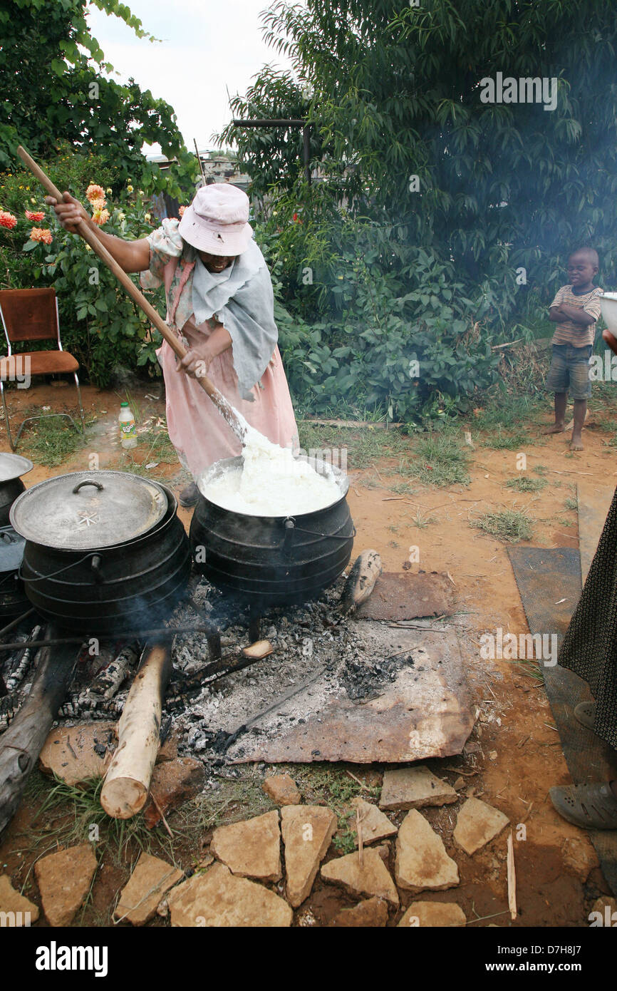 Cookout. Female cook steers been soup in large cooking pot outdoor Stock  Photo - Alamy