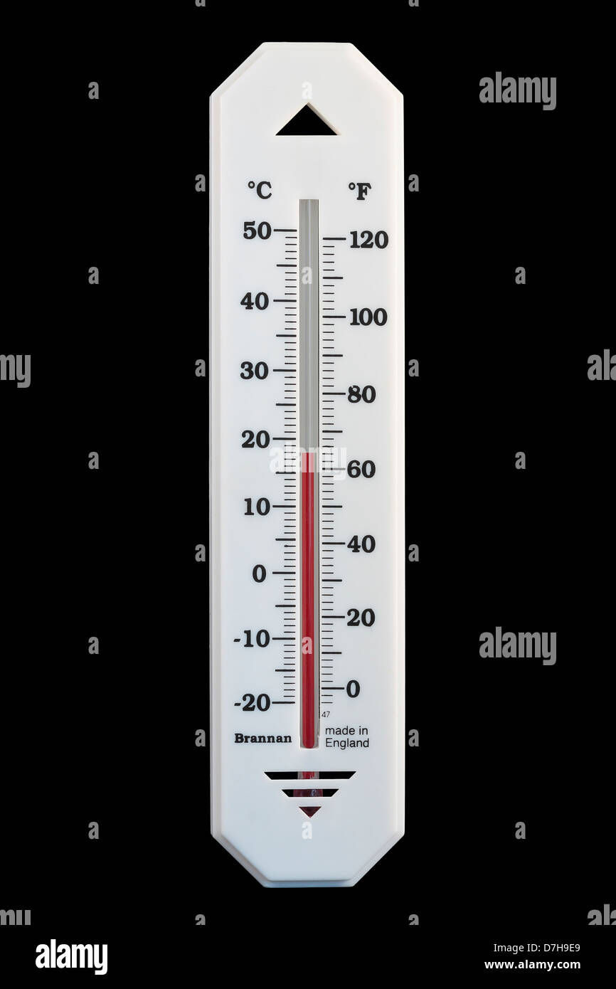 Celsius and Fahrenheit Alcohol in Glass Thermometer reading 18ºC 64ºF isolated on black background Stock Photo