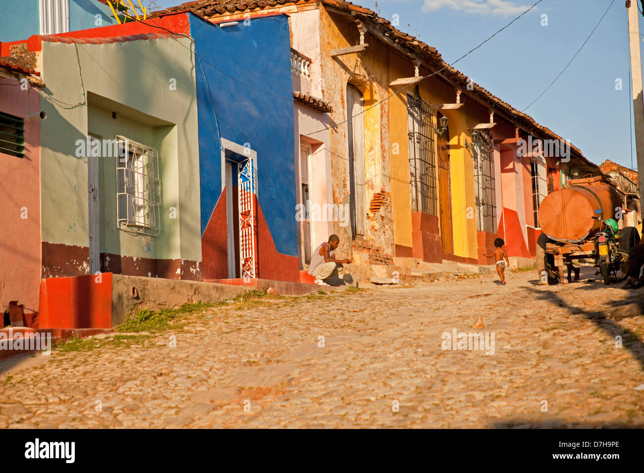 typical cobblestone street with colourful homes in the old town of Trinidad, Cuba, Caribbean Stock Photo