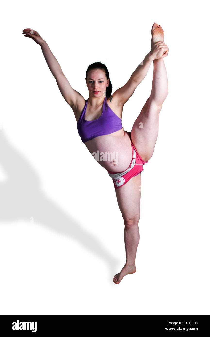 Young flexible Woman in her 20's, nine months pregnant. Model release available Stock Photo