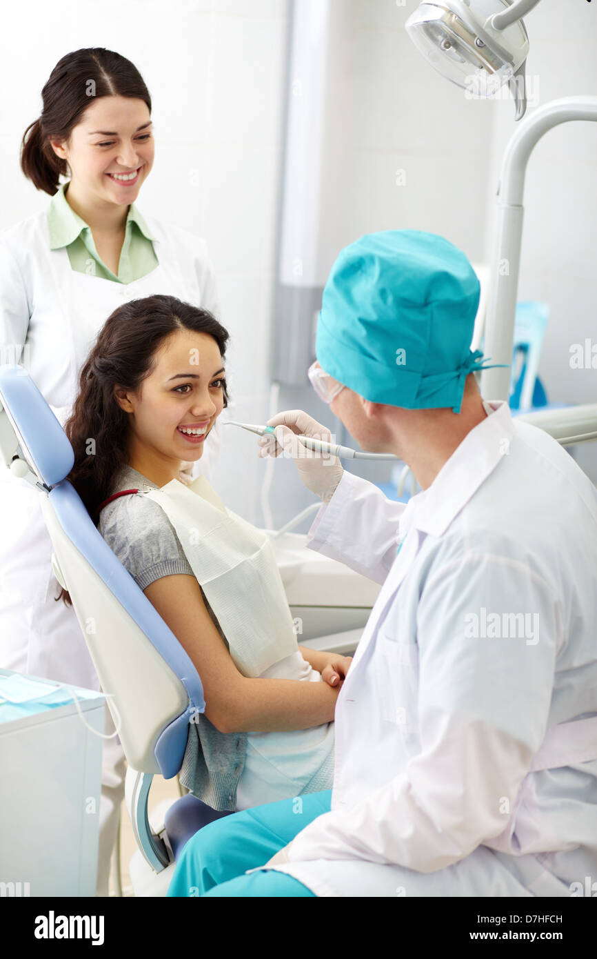 Cheerful patient receiving dental care hires stock photography and