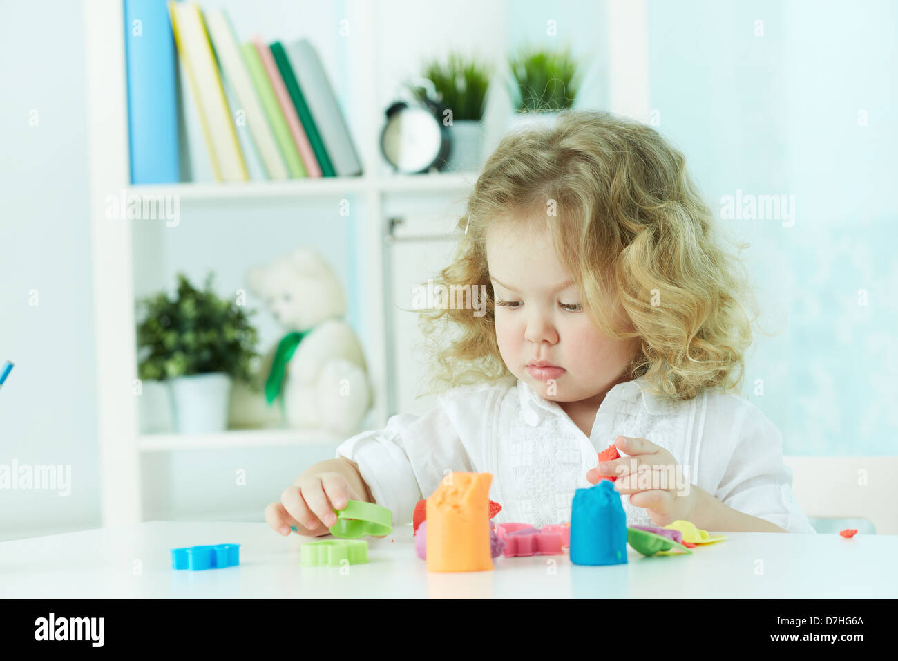 Little girl modeling with clay at kindergarten Stock Photo Alamy