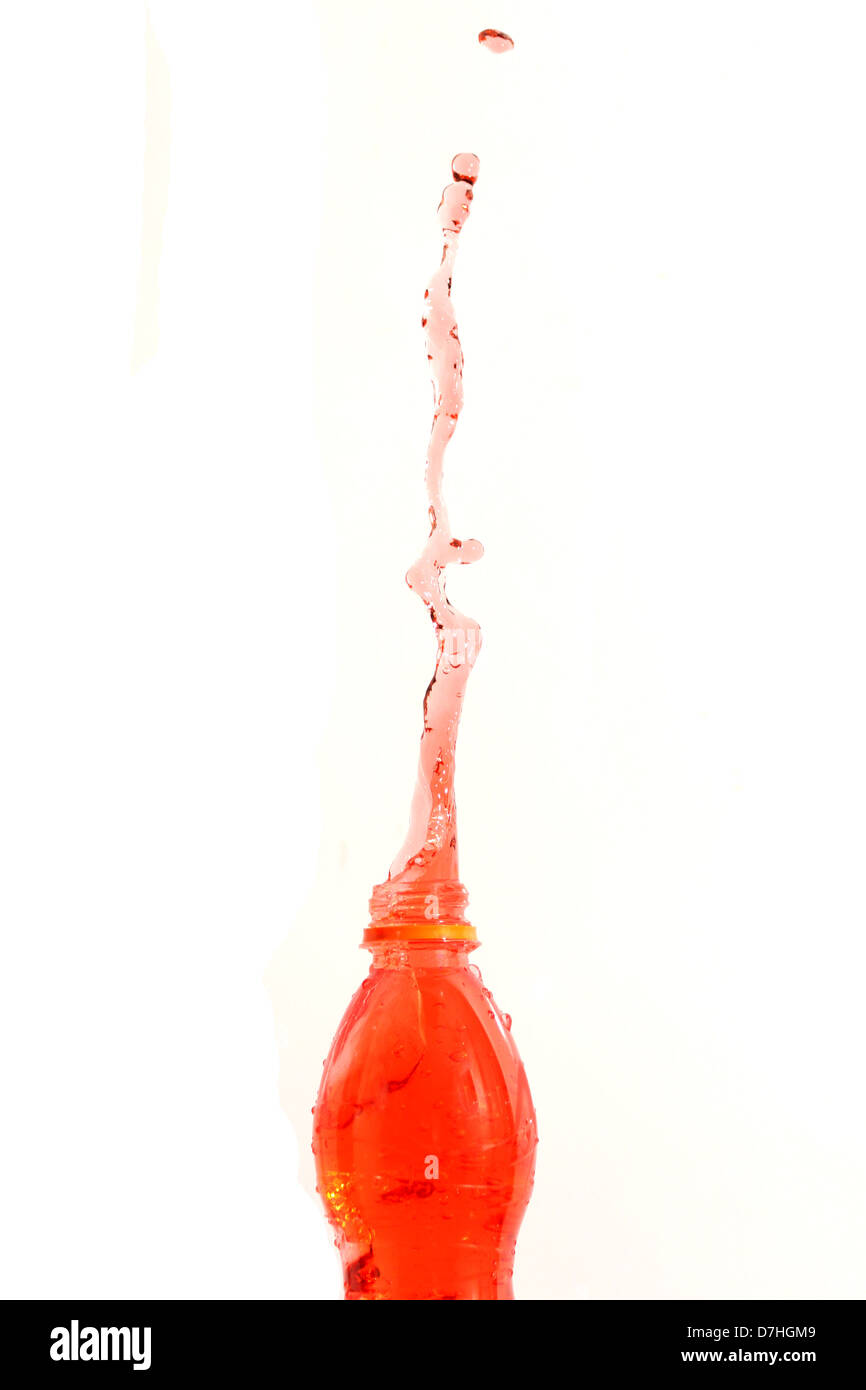 The Red water shoot form Bottle on the white Background. Stock Photo