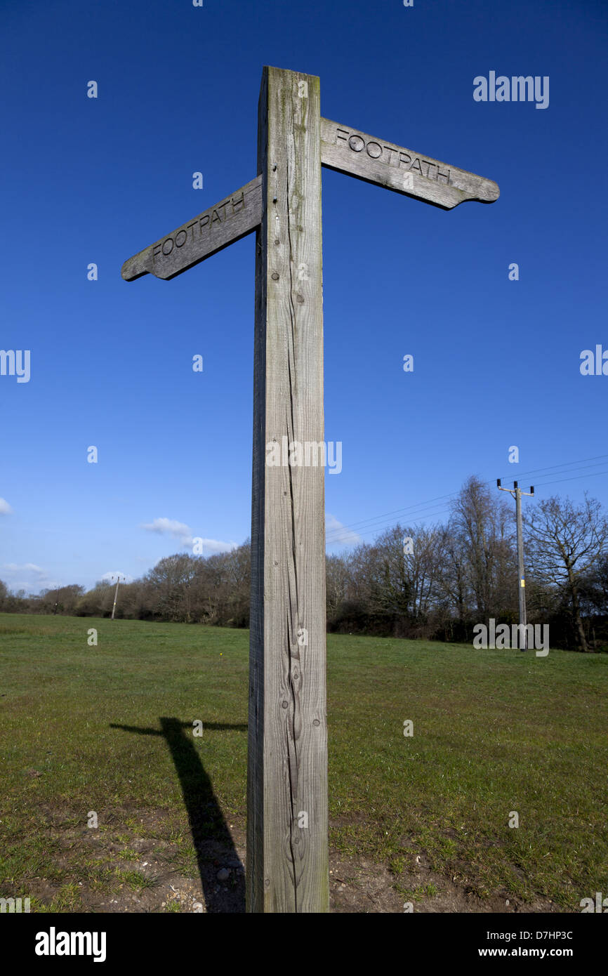 Wooden footpath signpost against clear blue sky Stock Photo