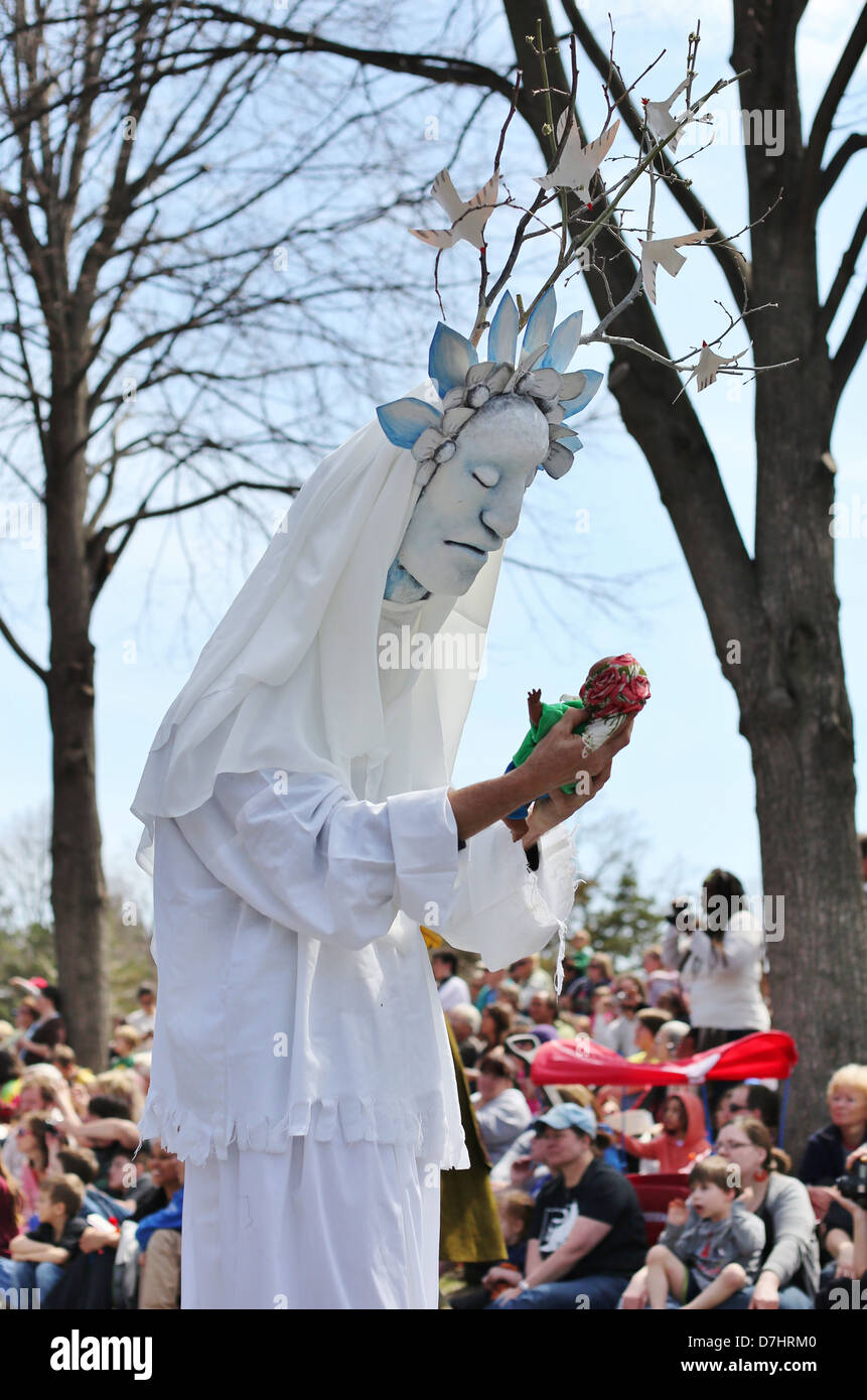 A giant puppet depicting nature, holding a puppet baby Stock Photo Alamy