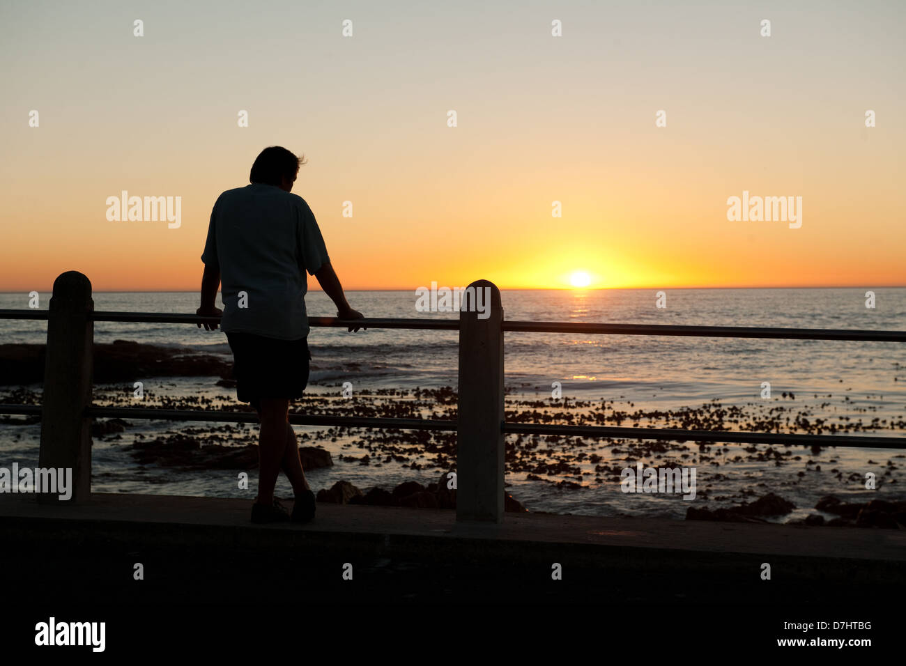 man watching the sunset, Sea Point, Cape Town, South Africa Stock Photo