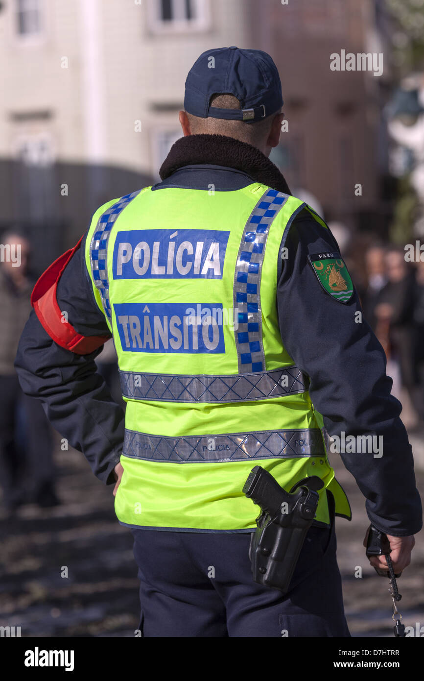 Portugese traffic policeman closeup from behind wearing hi-vis jacket Stock Photo