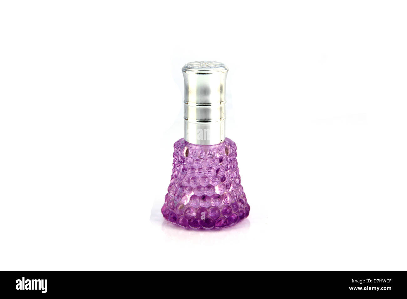 The violet Perfume bottle resting on a white background. Stock Photo