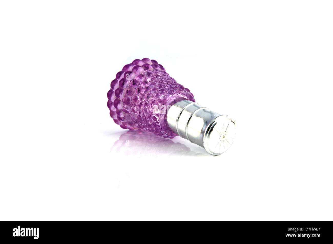 The violet Perfume bottle resting on a white background. Stock Photo