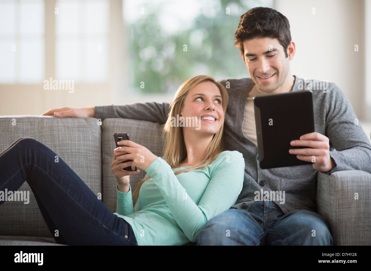 Couple using tablet pc and smartphone Stock Photo