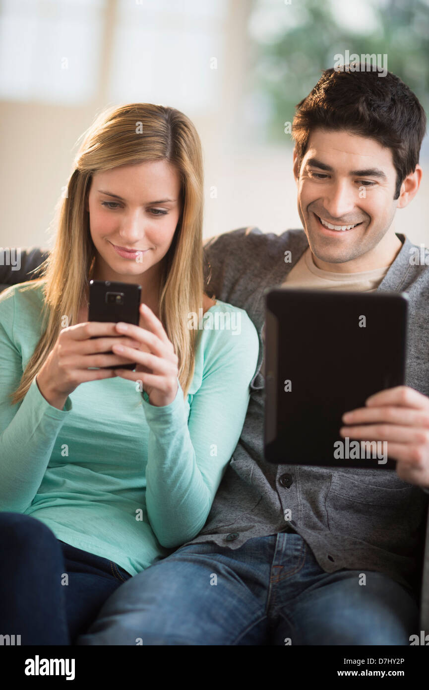 Couple using tablet pc and smartphone Stock Photo