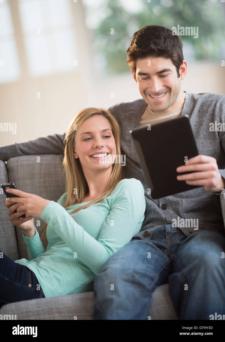 Couple using tablet pc and smartphone Stock Photo