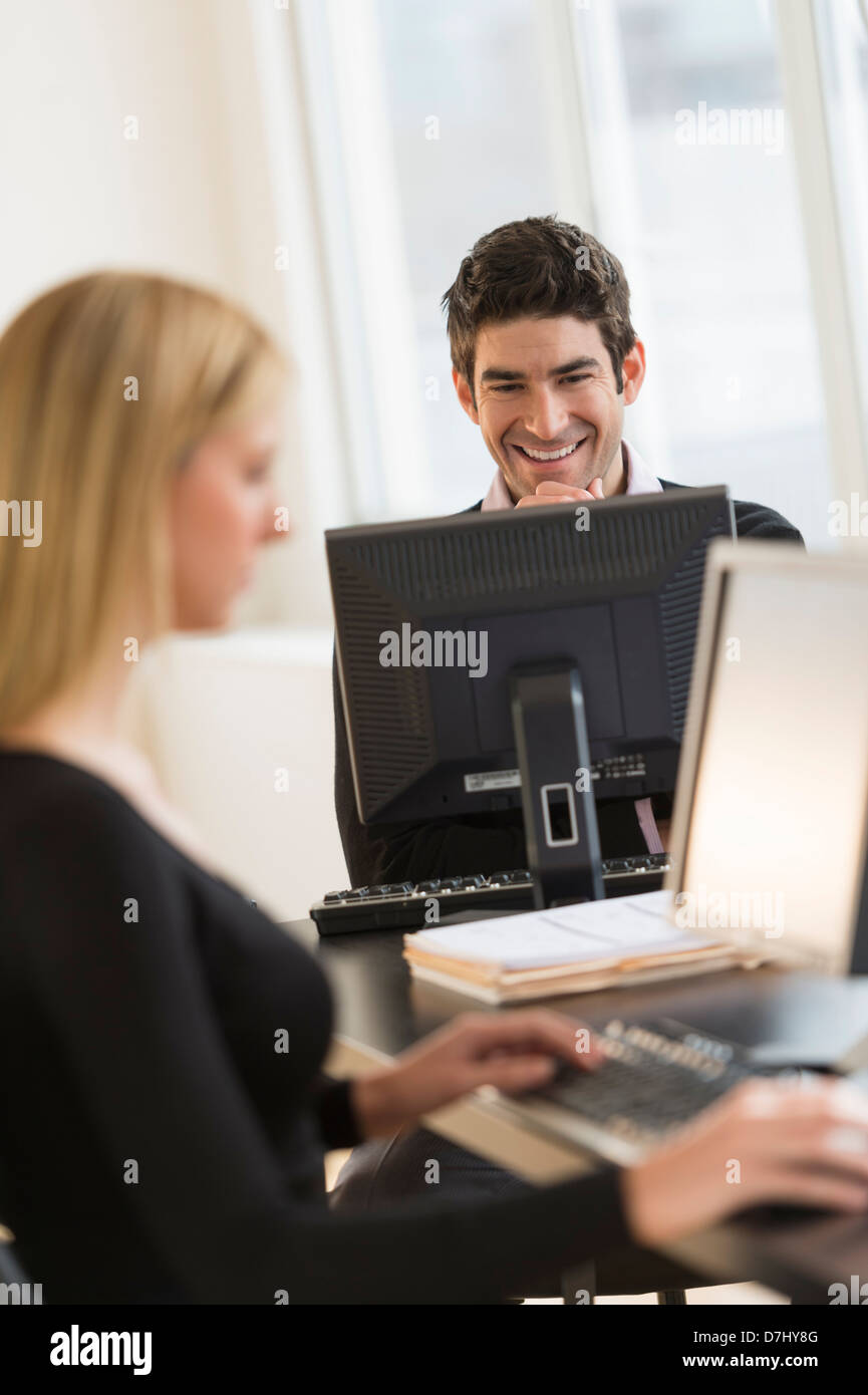 Business man and woman working in office Stock Photo - Alamy