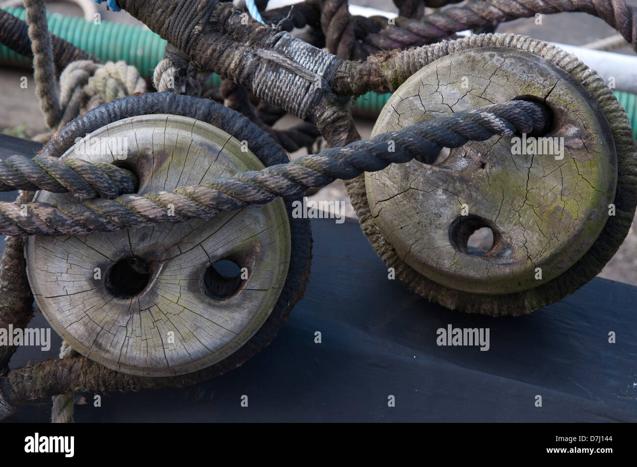 rigging blocks,wooden,ropes, rigging, on shore for repairs,worn, weathered, semi close up Stock Photo