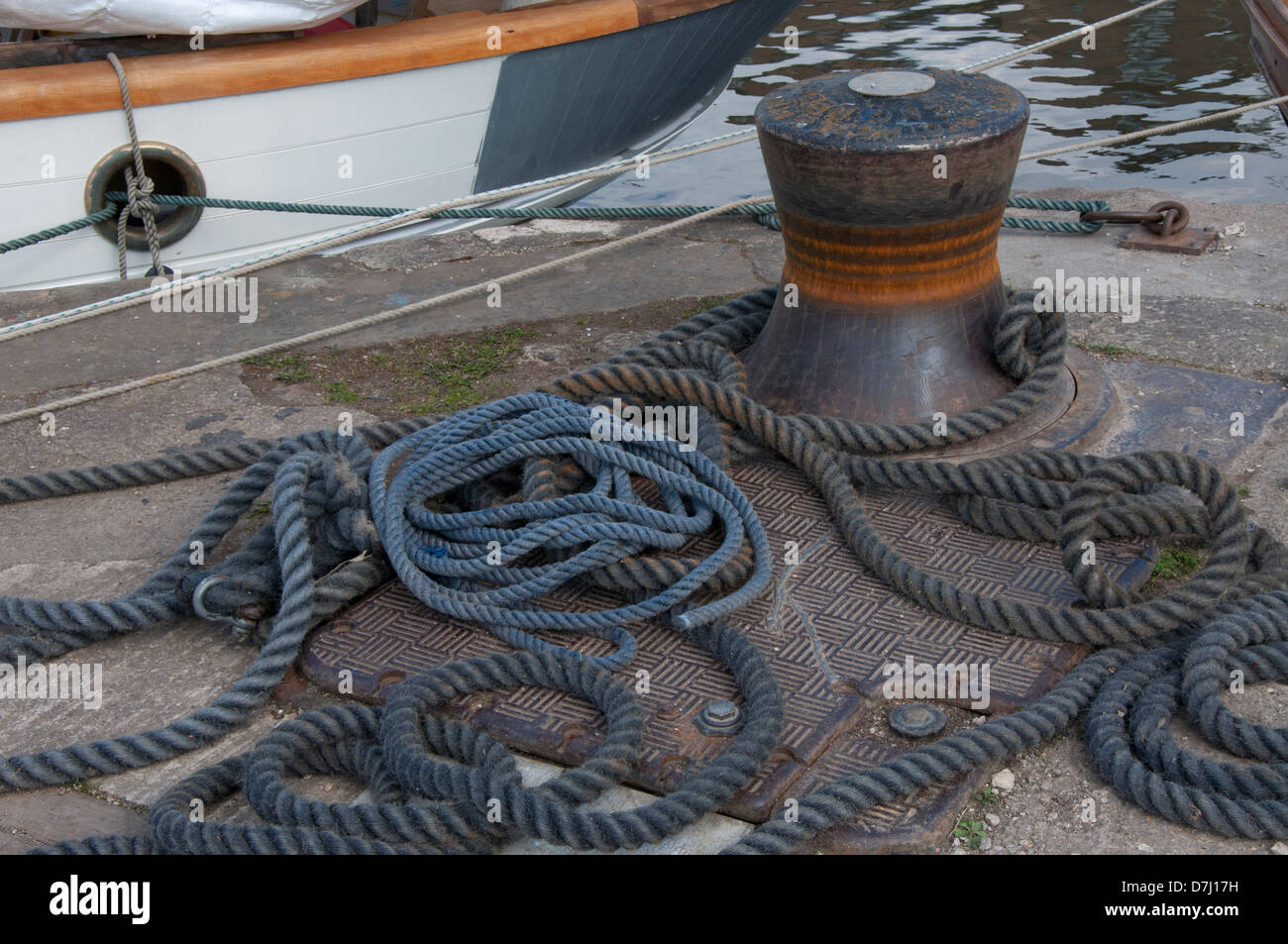 boat mooring ropes, bollard, quayside,laid on ground, sunlit Stock