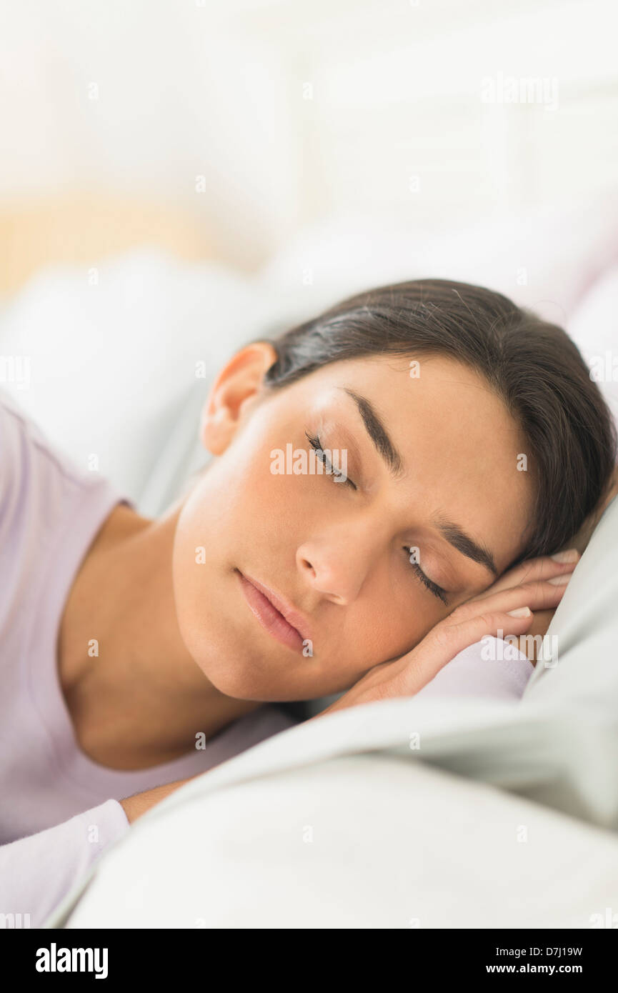Woman sleeping in bed Stock Photo