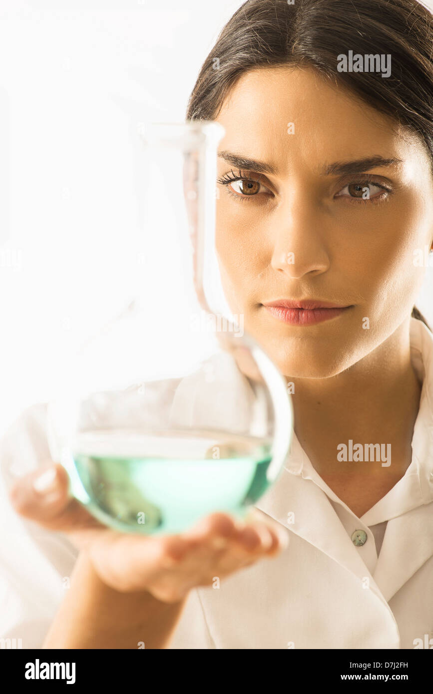 Woman holding beaker with liquid Stock Photo