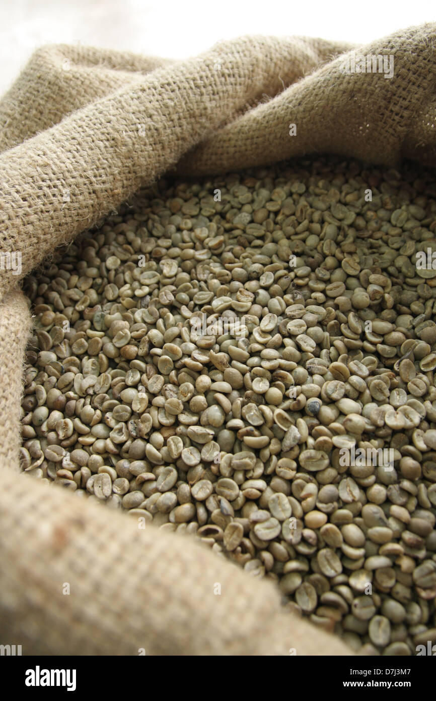 Un-roasted coffee beans in sack Stock Photo - Alamy