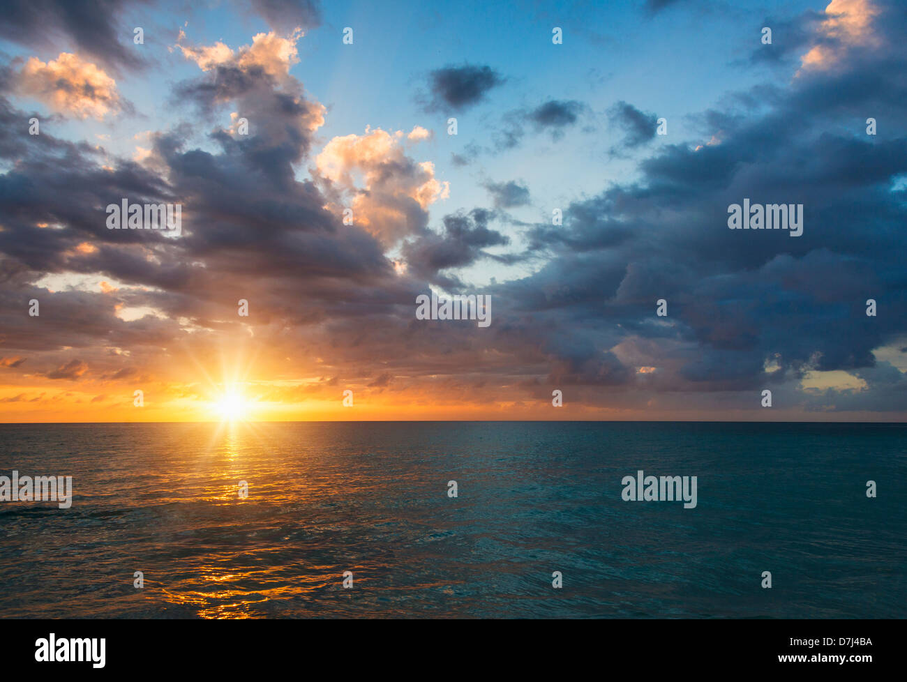 Jamaica, Sun setting over sea Stock Photo