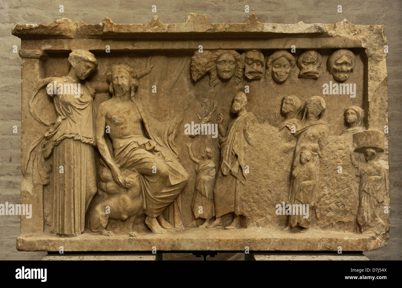 Votive stele depicting a sacrificial procession to Dionysus and Artemis for the win in a contest of theater. Votive offering. Stock Photo