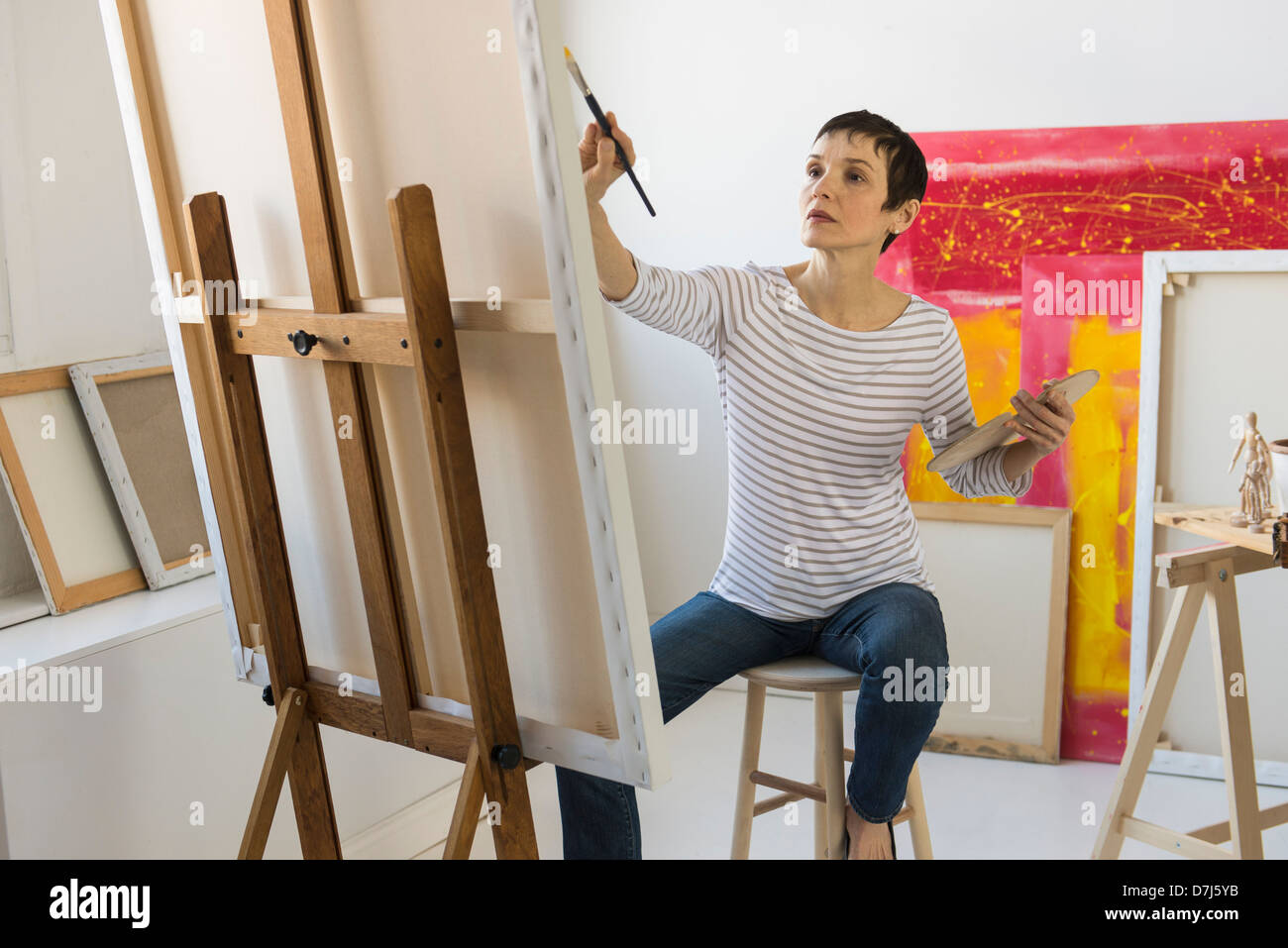 Female artist painting in her studio Stock Photo - Alamy