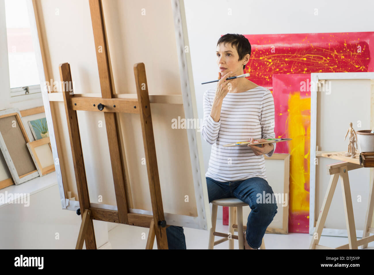 Female artist painting in her studio Stock Photo - Alamy