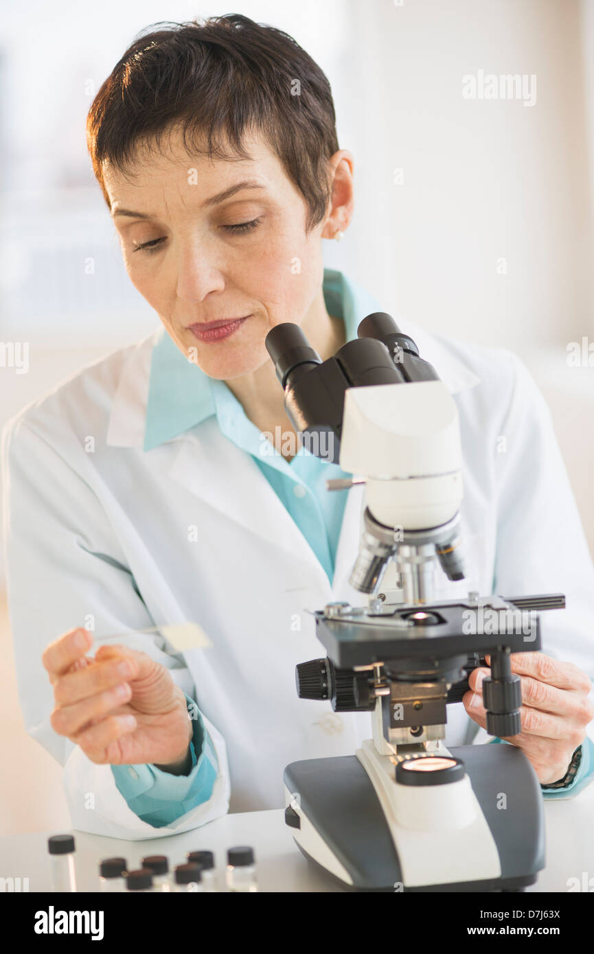 Woman working with microscope in laboratory Stock Photo Alamy