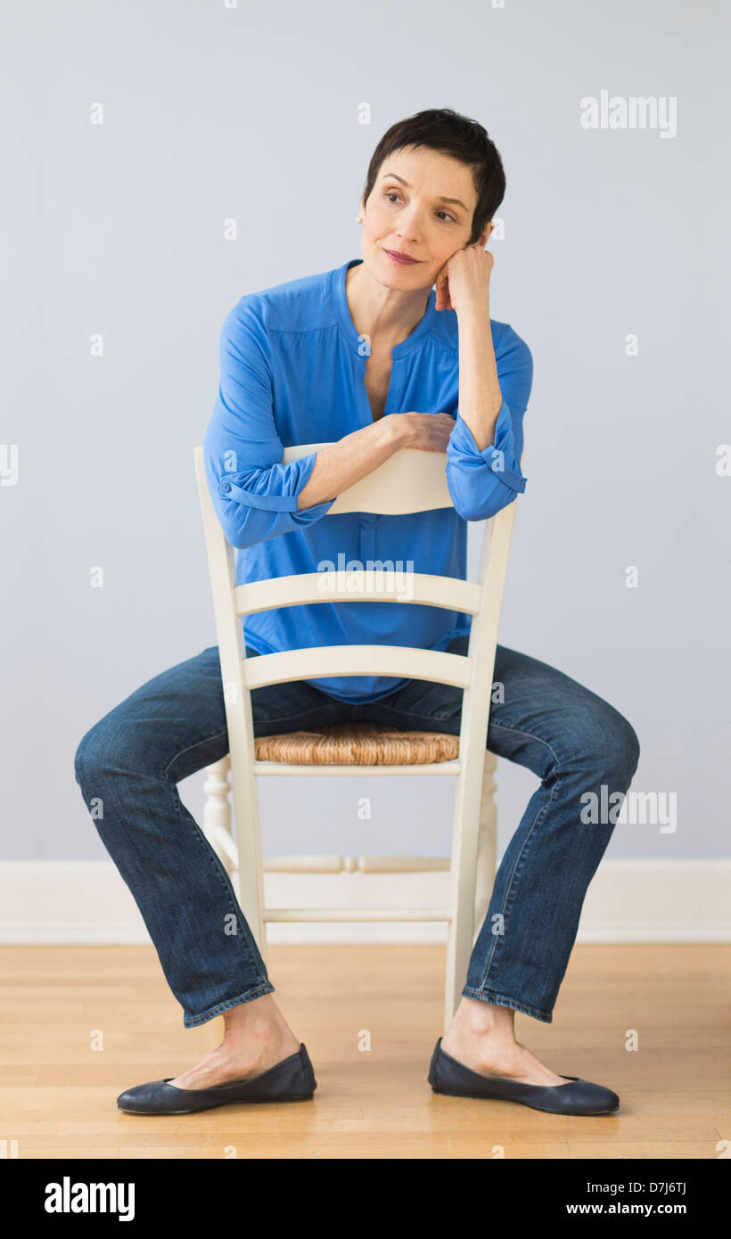 Mature woman sitting on chair hi-res stock photography and images - Alamy