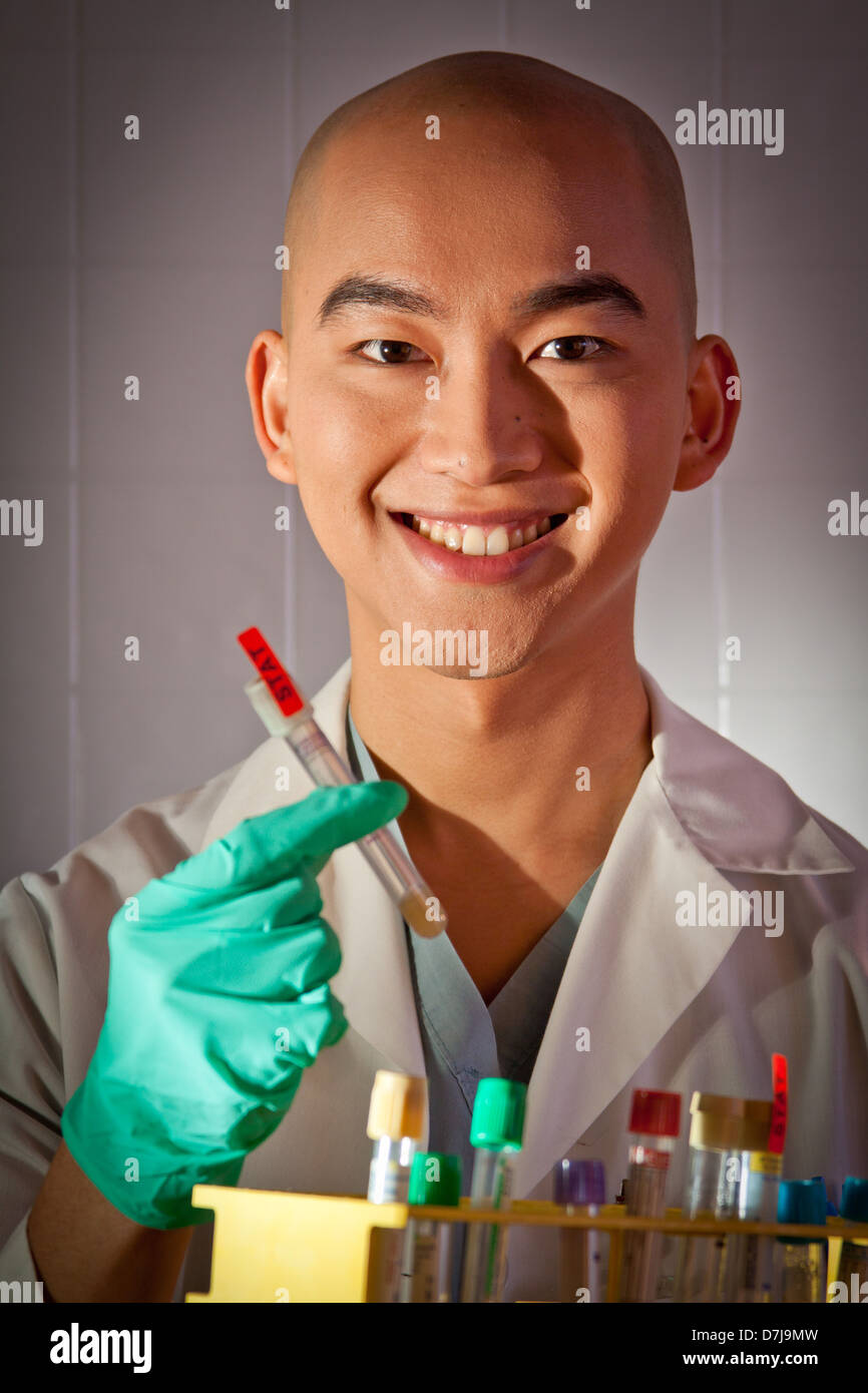 Portrait of a lab technician holding test tube. Stock Photo