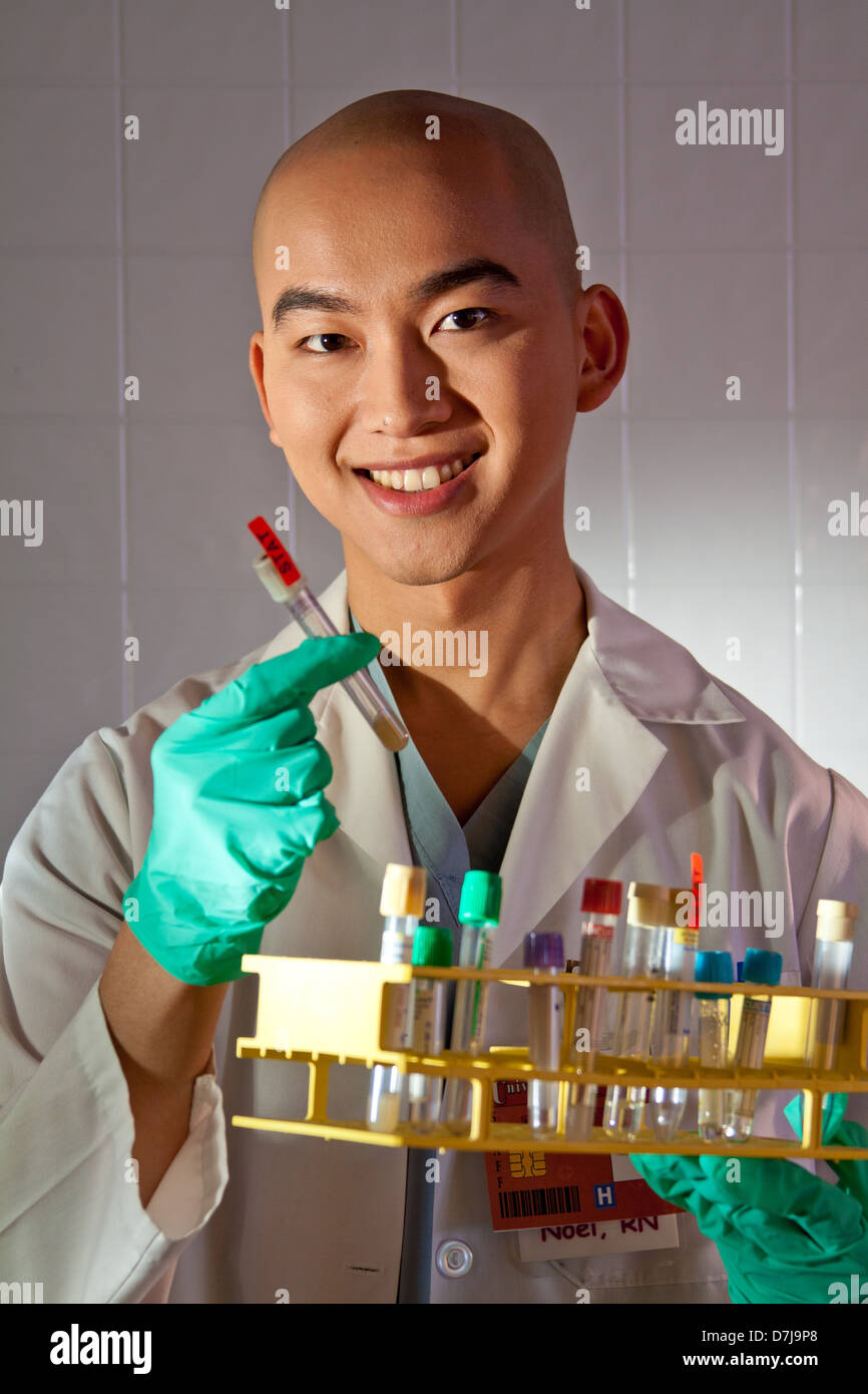 Portrait of a lab technician holding test tube. Stock Photo