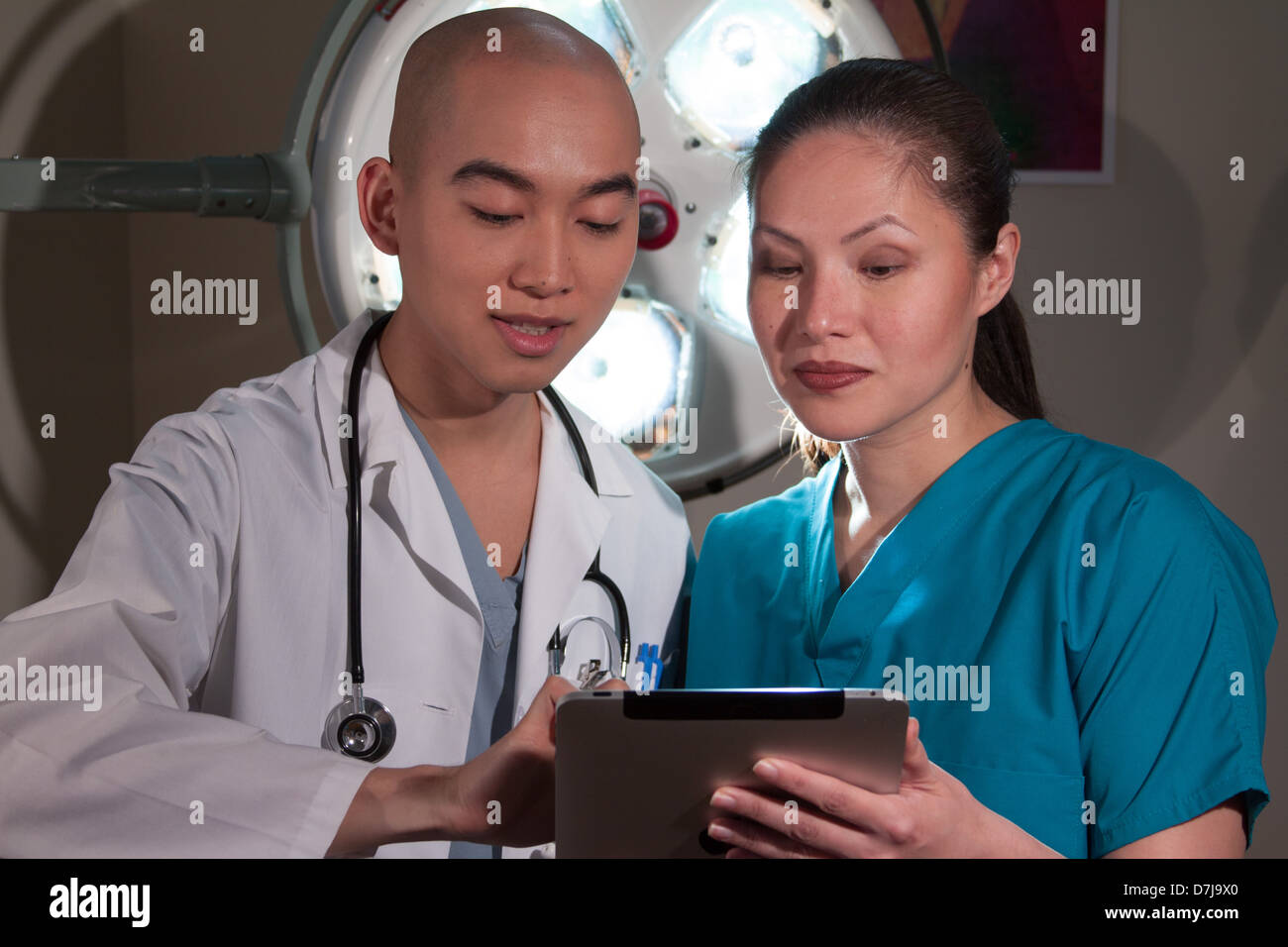 Health care professionals reviewing information on tablet Stock Photo