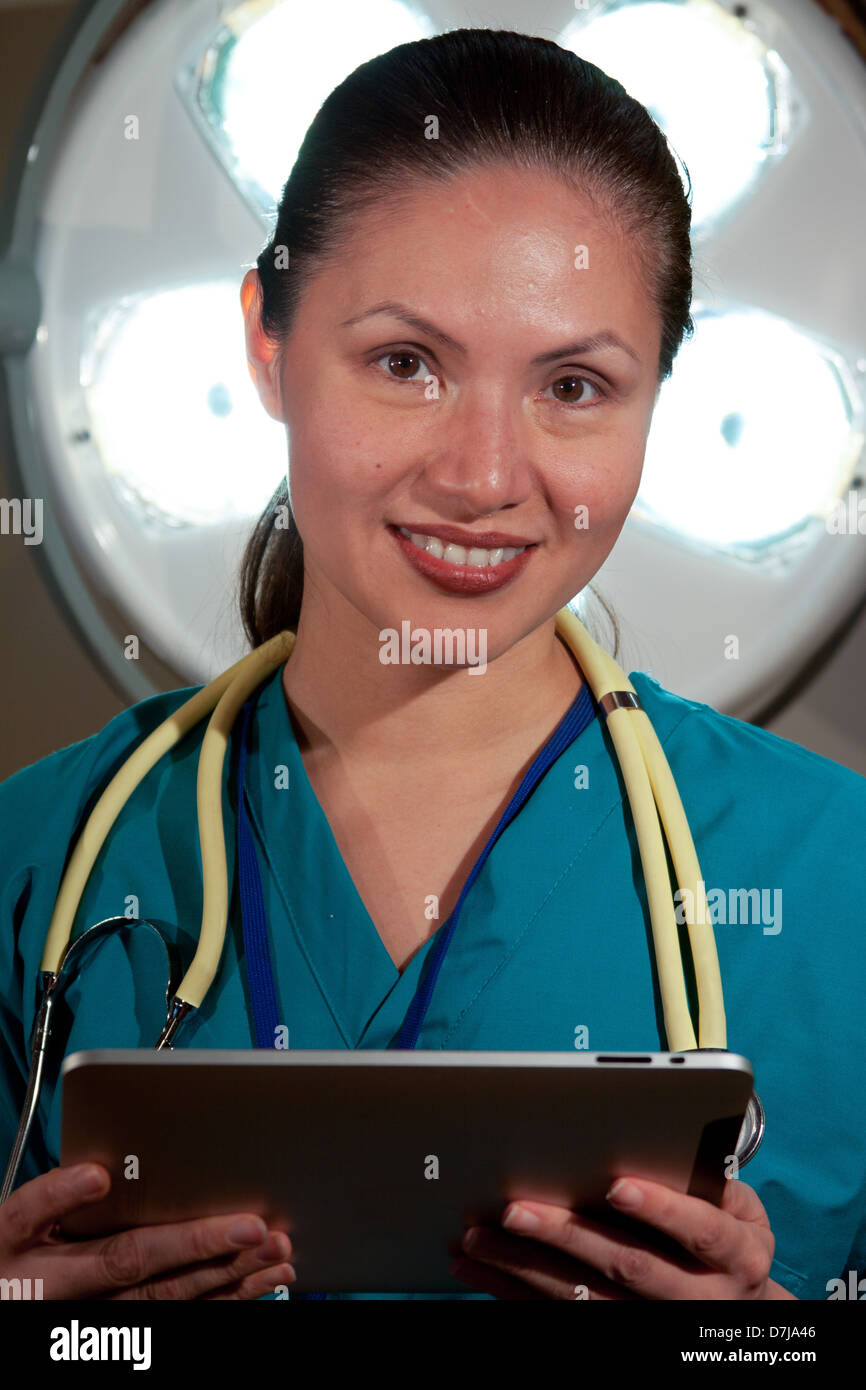 Portrait of Nurse, smiling, holding a tablet. Stock Photo