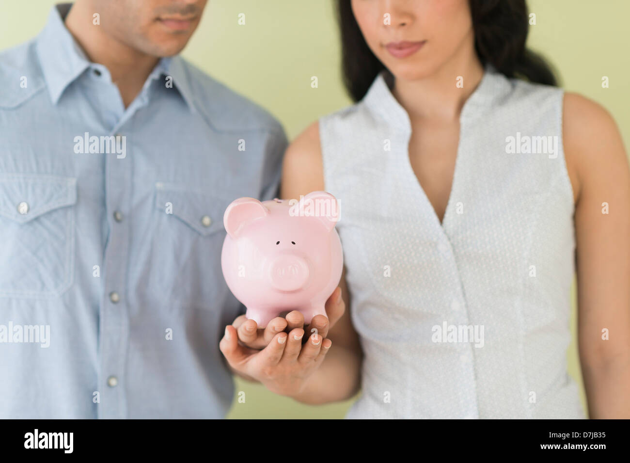 Young couple holding piggy bank Stock Photo - Alamy