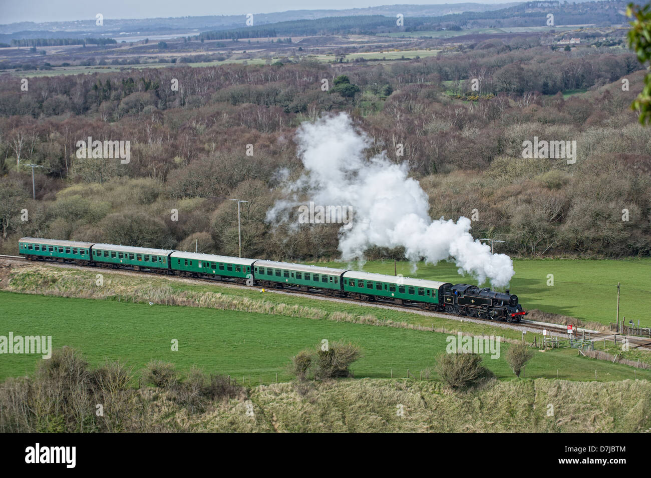 Swanage steam railway train approaching Corfe Castle railway station ...