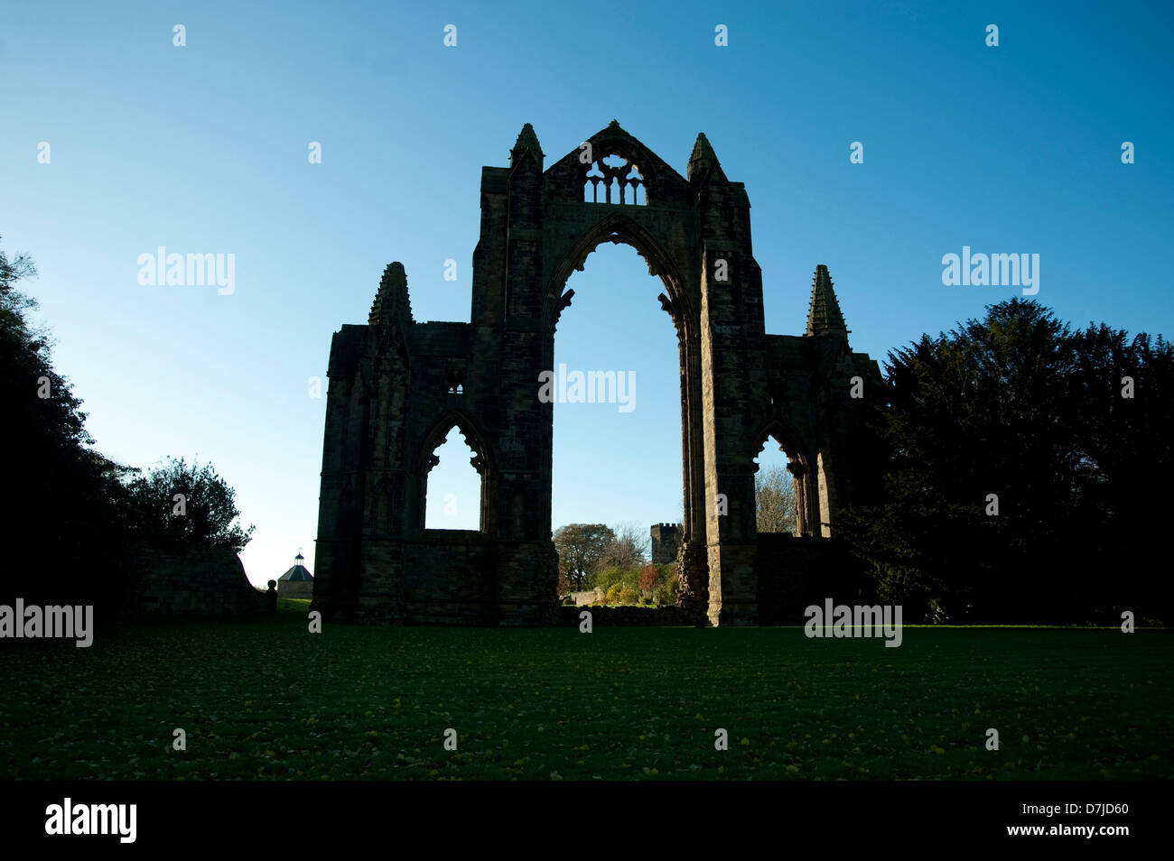Guisborough Church in silhoutte,grounds,trees,bushes,blue skies Stock Photo