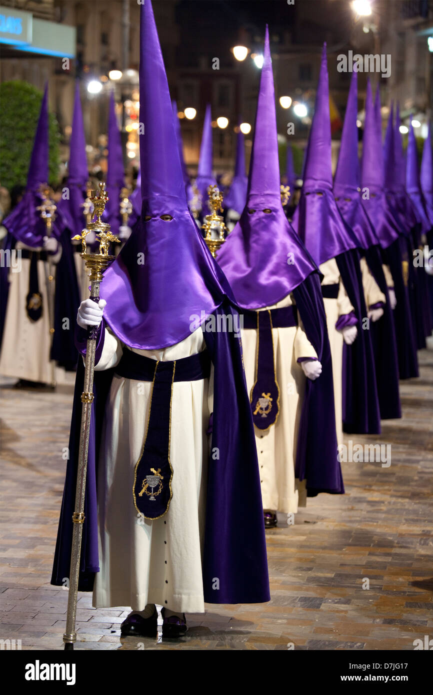 Nazarenos in a night time procession during Semana Santa (Holy Week) in Cartagena, Spain Stock Photo