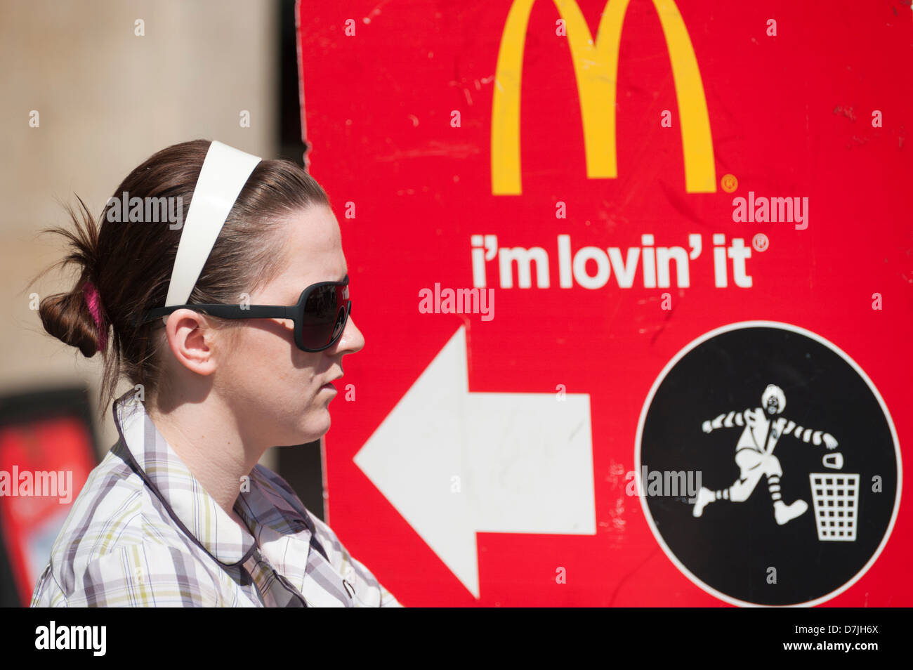 A young woman holding a McDonald's restaurant adverting placard Stock Photo