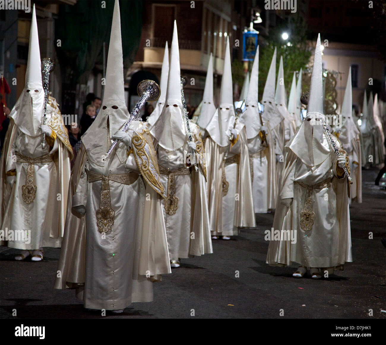 Nazarenos in a night time procession during Semana Santa (Holy Week) in